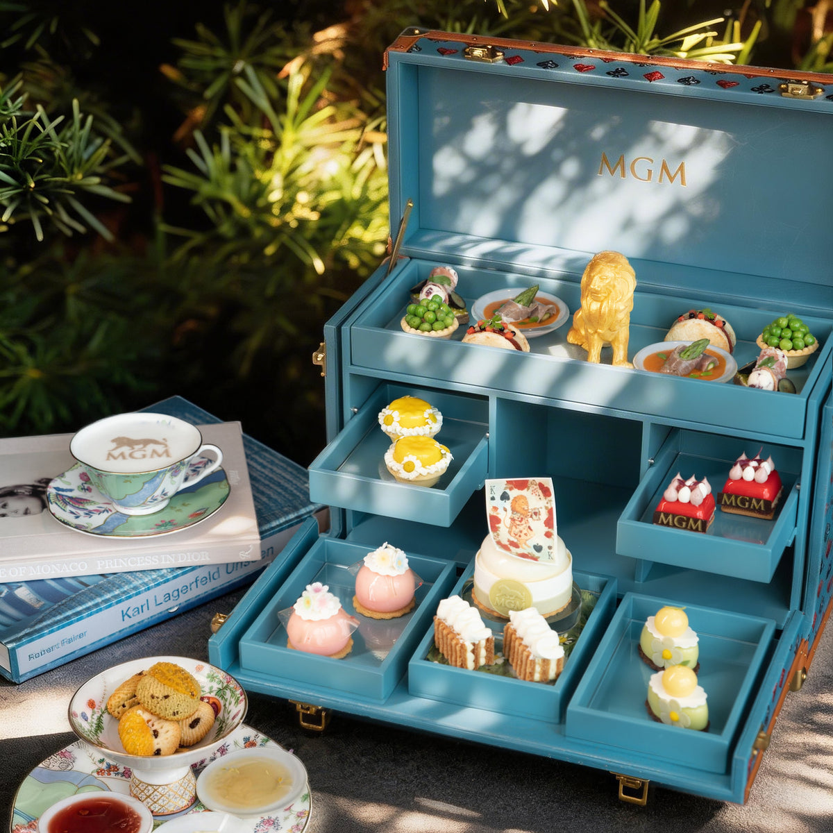Vinidec bespoke luxury blue lacquered afternoon tea trunk crafted for MGM, featuring gold hot-stamped branding and multi-tier pastry compartments