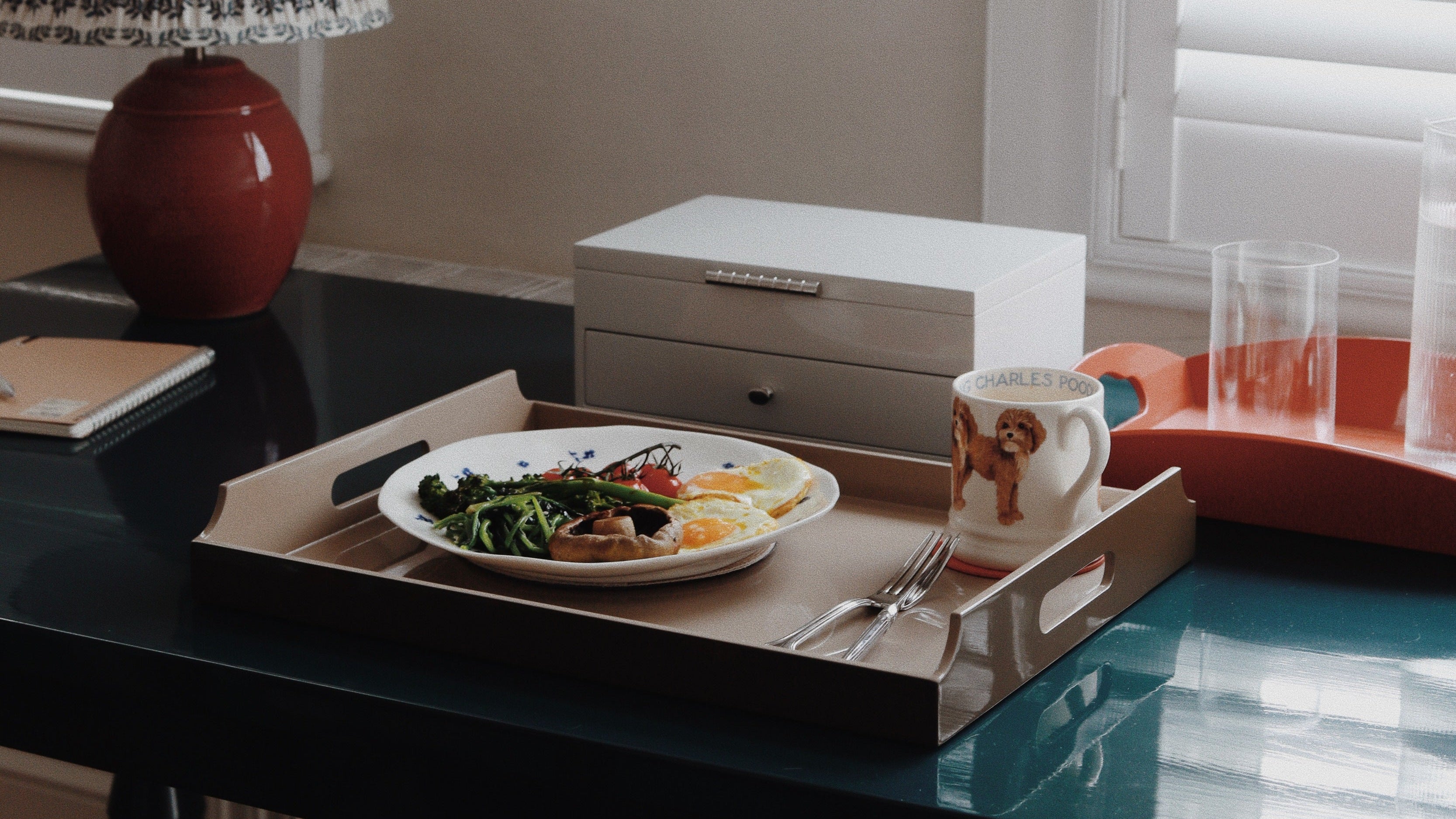 Vinidec taupe lacquered serving tray with cutout handles, styled with breakfast plate and mug on a dark gloss dining table