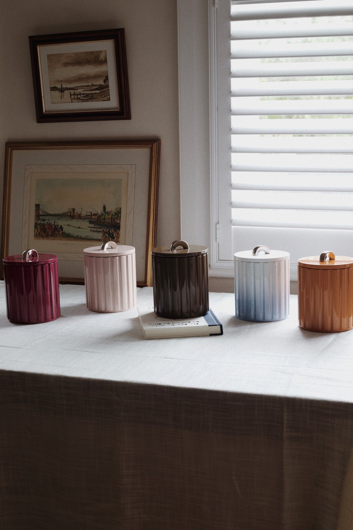 Row of five Vinidec Fluted Lacquer Ice Buckets in fall tones including terracotta, sage, and espresso
